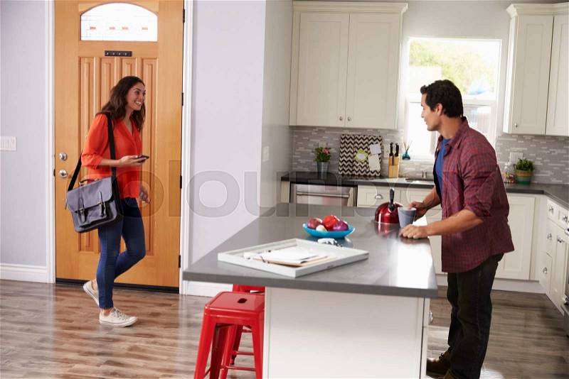 Man Greeting Woman Returning Home From Work, stock photo