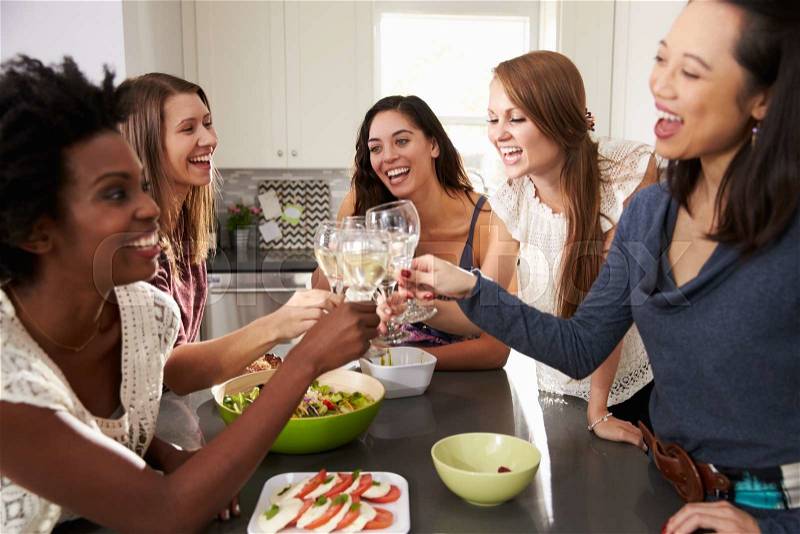 Group Of Female Friends Enjoying Pre Dinner Drinks At Home, stock photo