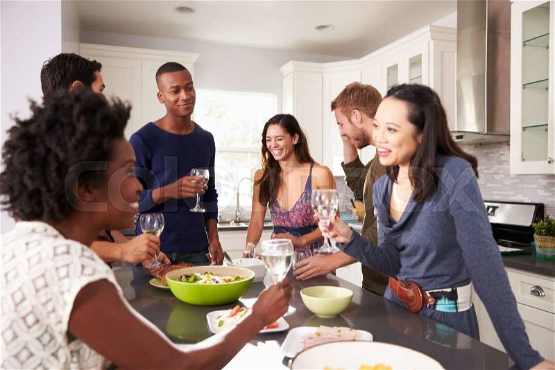 Group Of Friends Enjoying Pre Dinner Drinks At Home, stock photo