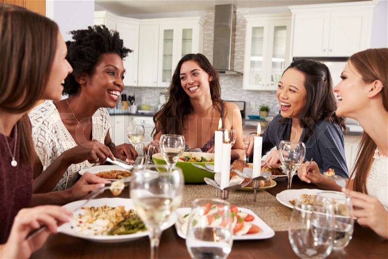 Group Of Female Friends Enjoying Dinner Party At Home, stock photo
