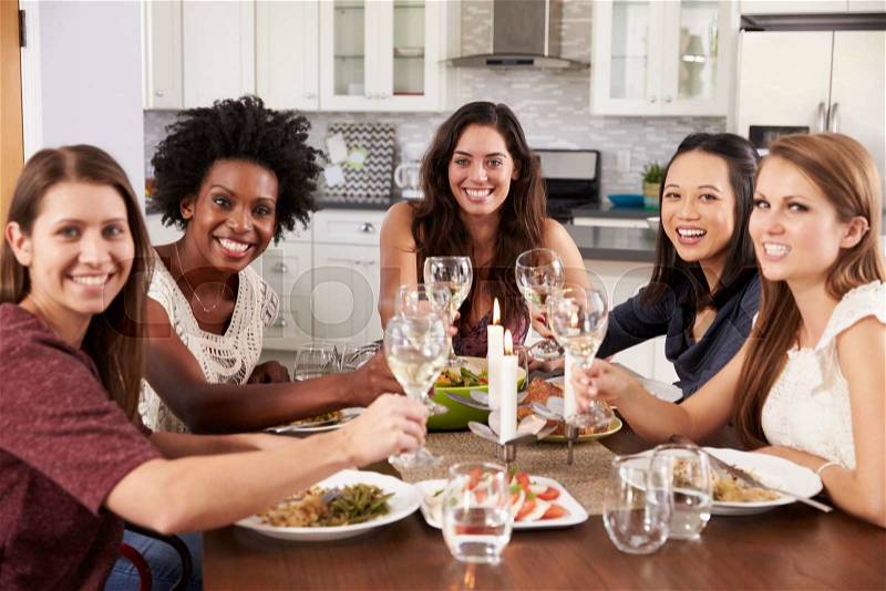 Group Of Female Friends Enjoying Dinner Party At Home, stock photo
