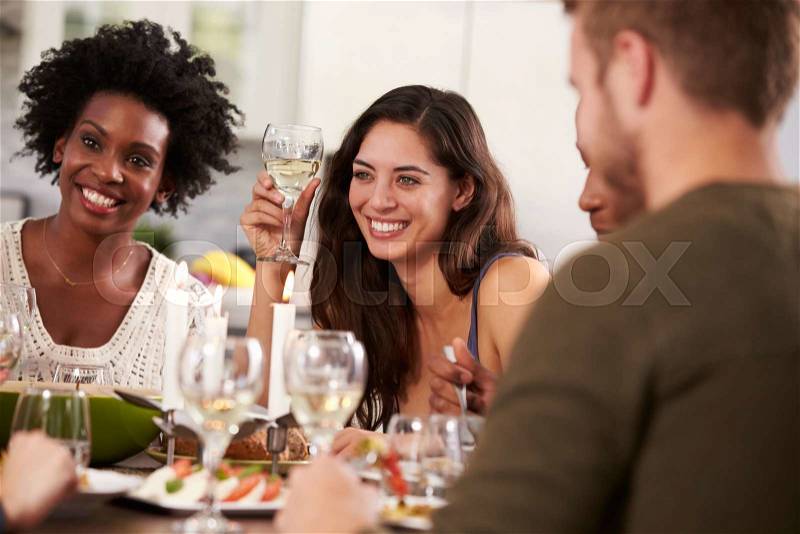 Group Of Friends Enjoying Dinner Party At Home, stock photo