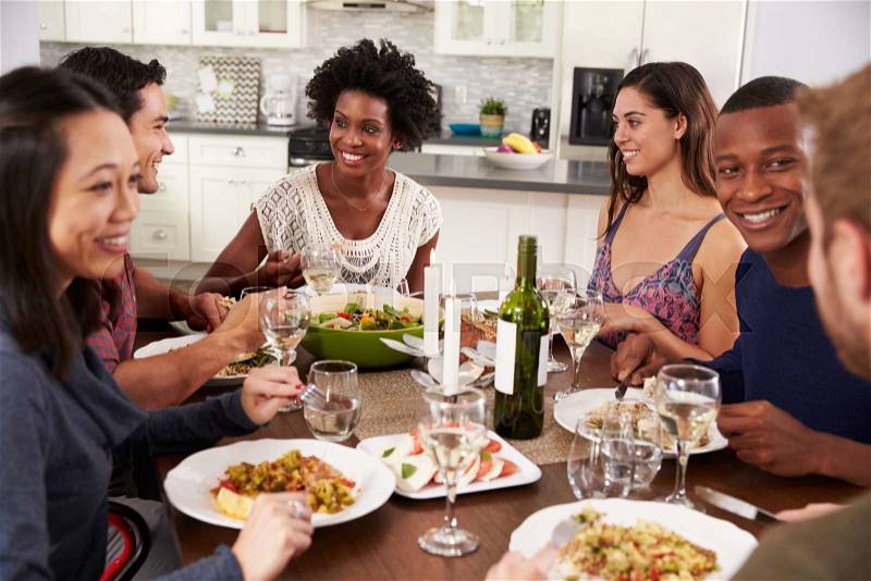 Group Of Friends Enjoying Dinner Party At Home, stock photo