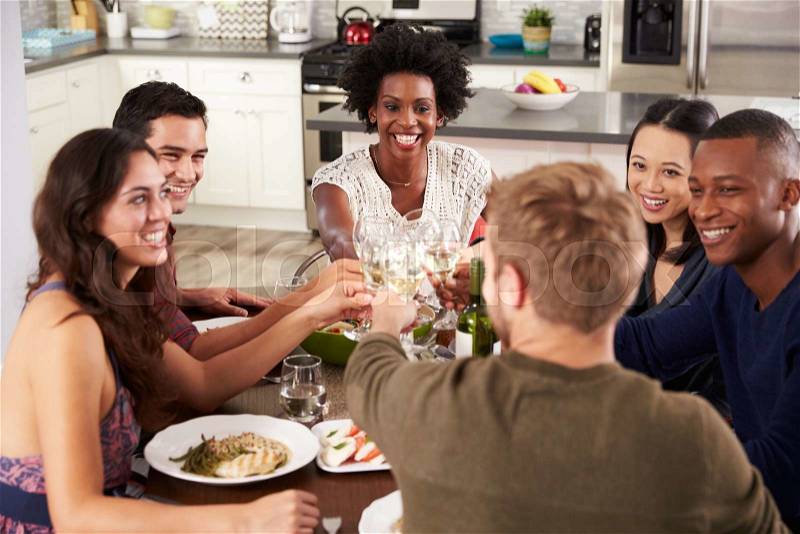 Group Of Friends Making A Toast At Dinner Party, stock photo