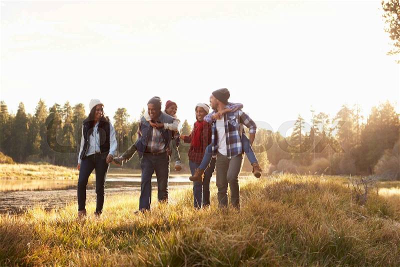 Extended Family Group Walking By Lake, stock photo