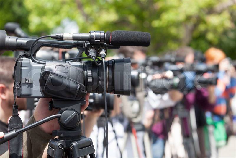 News conference. Covering an event with a video camera, stock photo