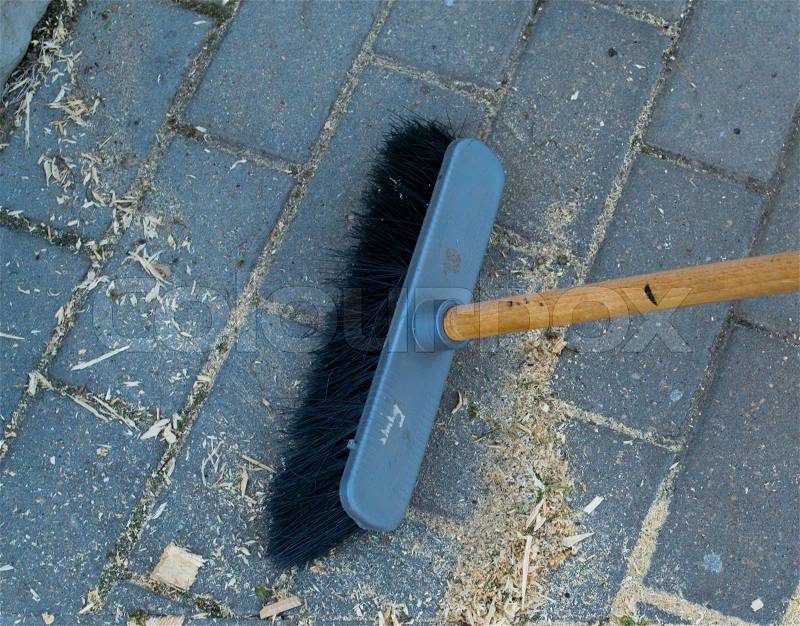 The brush sweeps a floor, stock photo