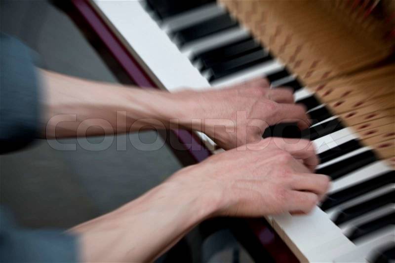 Young artist entertaining with jazz and blues on his piano in the street - Paris, France, stock photo
