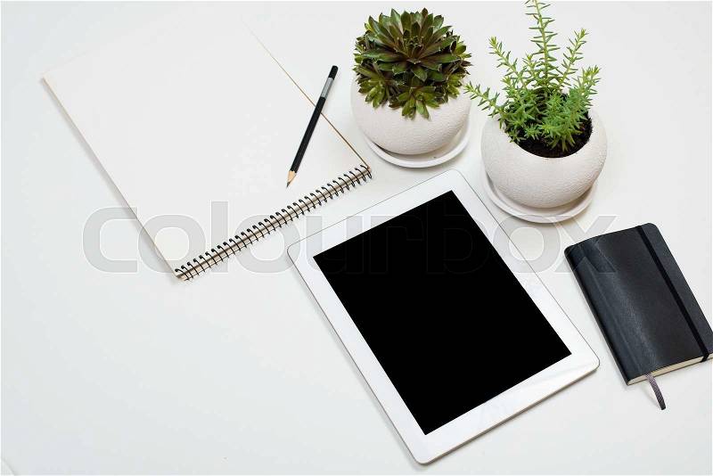 Tablet mock-up and office supplies on white tabletop background, contemporary workspace, stock photo