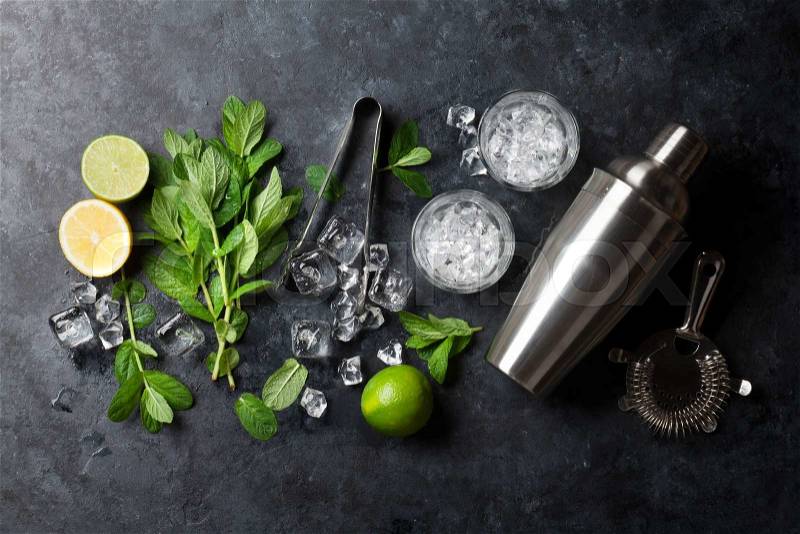 Mojito cocktail making. Mint, lime, ice ingredients and bar utensils. Top view, stock photo