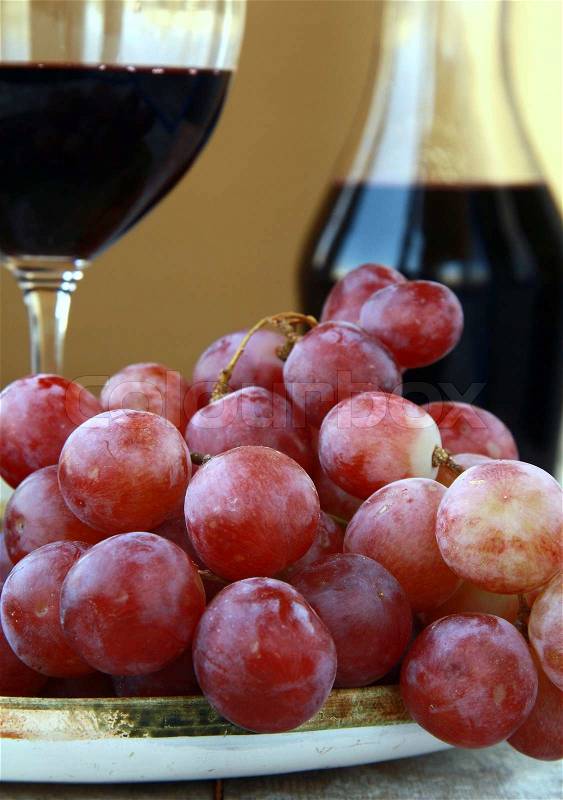 Large red ripe grapes and wine on the natural background, stock photo