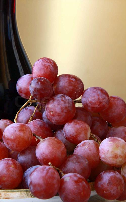 Large red ripe grapes and wine on the natural background, stock photo