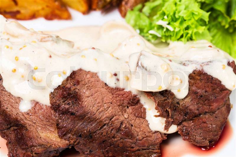 Sliced beef steak covered with delicious sauce. Macro. Photo can be used as a whole background, stock photo