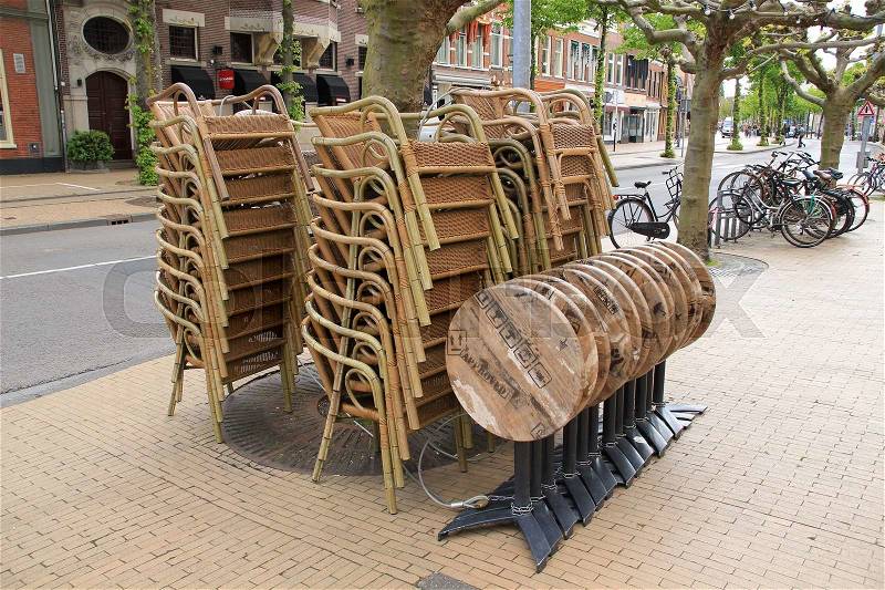 The restaurant is closed and the tables and chairs are cleaned up for the next day in the city Groningen in the summer, stock photo