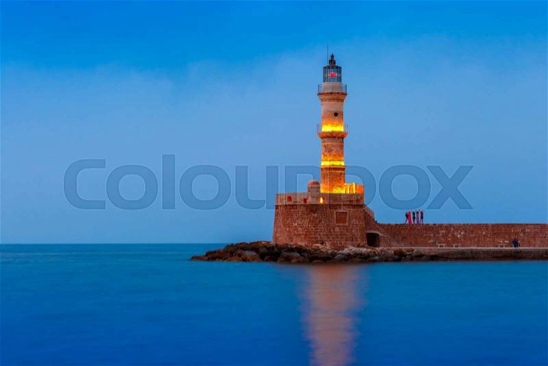 Picturesque view of Lighthouse in old harbour of Chania during twilight blue hour, Crete, Greece, stock photo