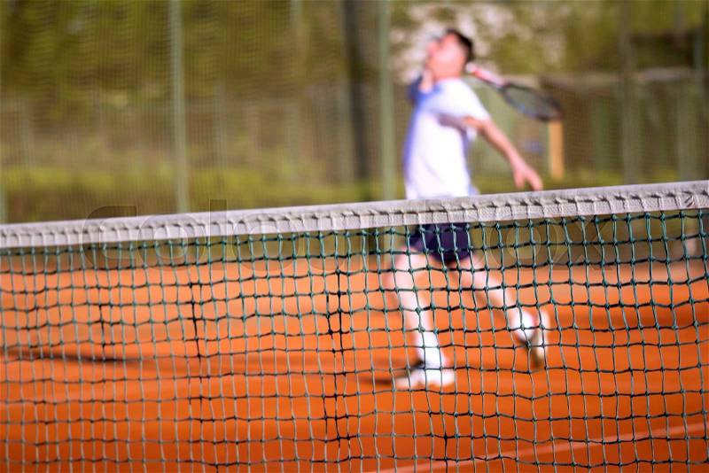 Tennis net, Man plays tennis, blurred motion, stock photo