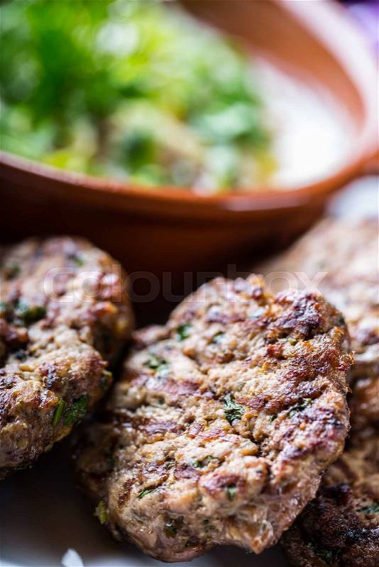 Burgers. Grill burgers. Minced burgers. Roasted burgers with grilled vegetable and herb decoration. Minced meat grilled in a hotel or restaurant, stock photo