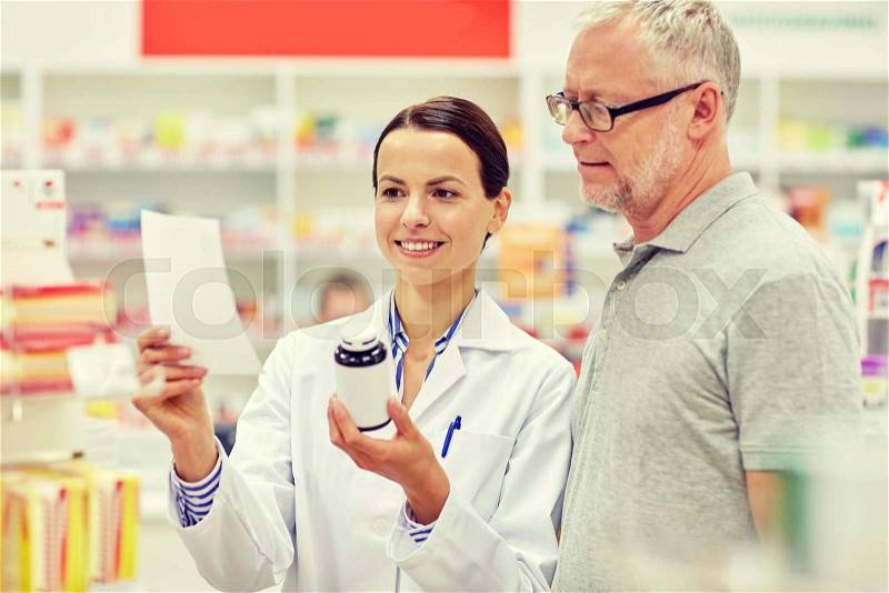 Medicine, pharmaceutics, health care and people concept - happy pharmacist and senior man customer with drug and prescription at drugstore, stock photo
