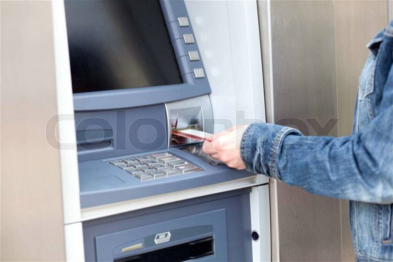 Take cash from the ATM, stock photo