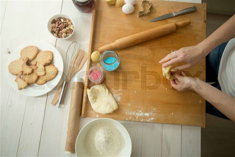 Toned photo of female hands making dough for holiday cookies, stock photo