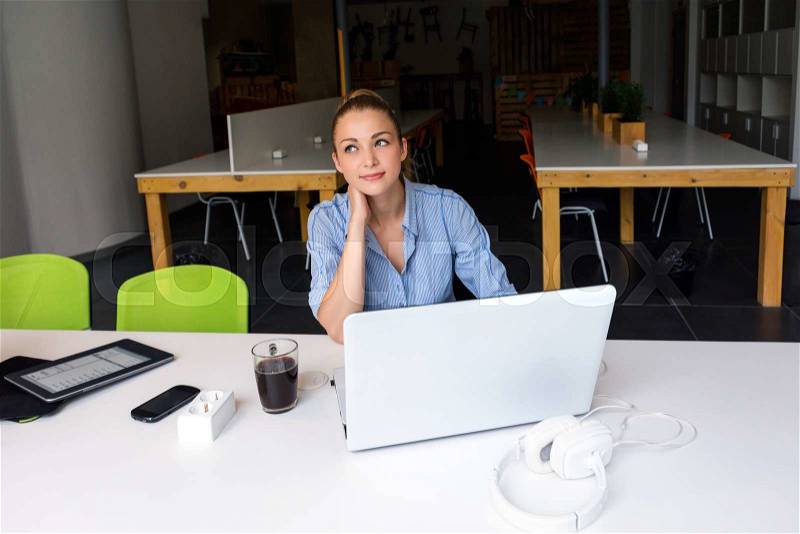 Business, technology and green office concept - young successful businesswoman with laptop computer at office. Beautiful woman using tablet computer, stock photo
