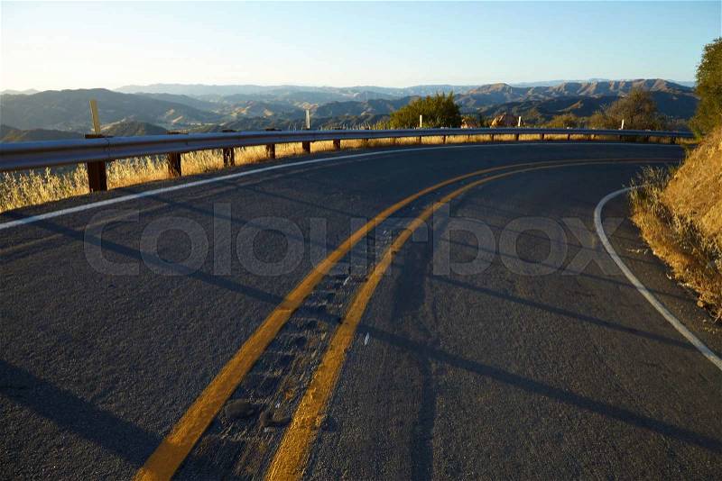 Road through the hills in Malibu at sunset California, stock photo