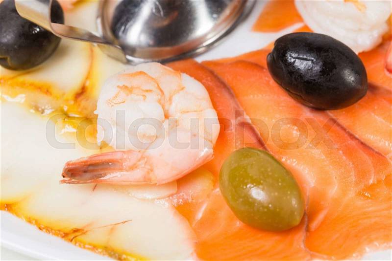 Delicious smoked salmon fish platter garnished with lemon and olives. Macro. Photo can be used as a whole background, stock photo