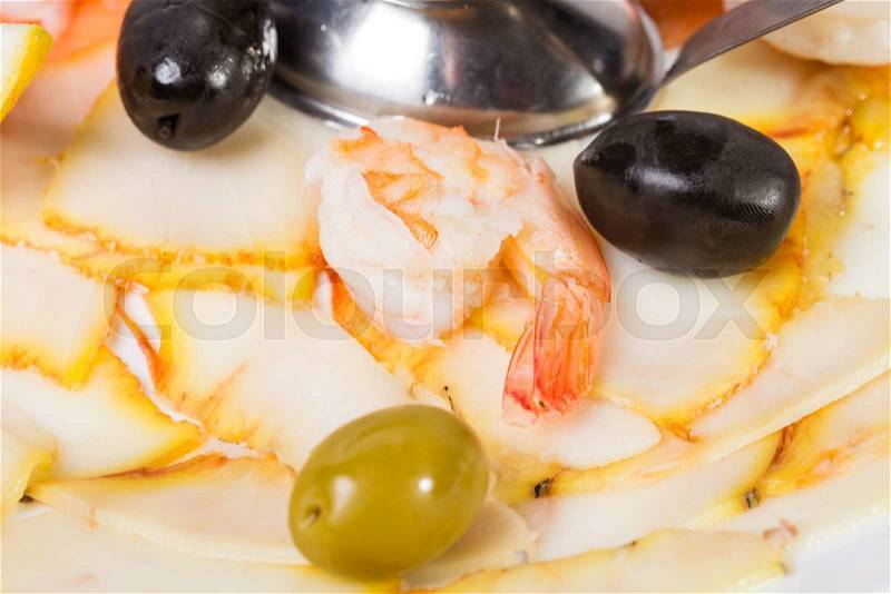 Delicious smoked salmon fish platter garnished with shrimps and olives. Macro. Photo can be used as a whole background, stock photo