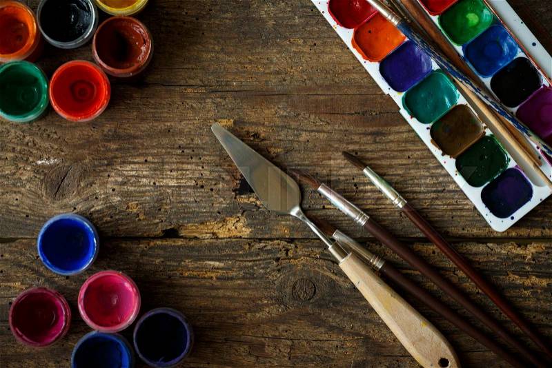 Art of Painting. Painting set: brushes, paints, watercolor, acrylic paint on a wooden background top down view, stock photo