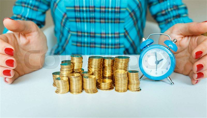 Protect new business start-up concept - with hand, coin and and blue alarm clock, stock photo