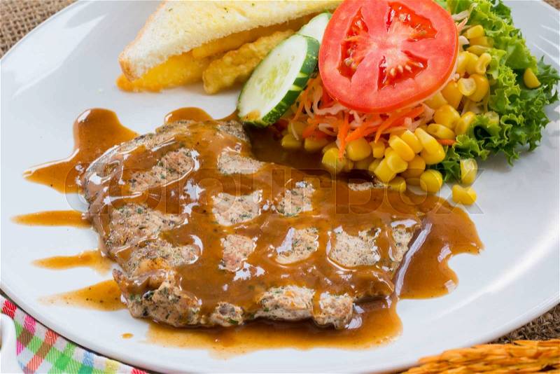 Beef steak with black pepper sauce , salad and French fries on sack background, stock photo