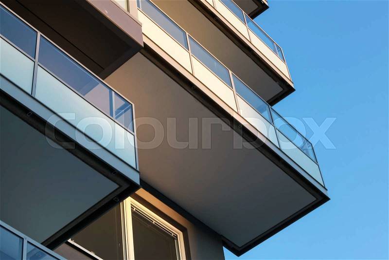 Abstract fragment of contemporary architecture, balconies with glass railings, stock photo