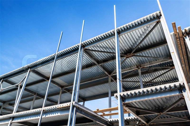Modern industrial building is under construction. Steel beams and decking, stock photo