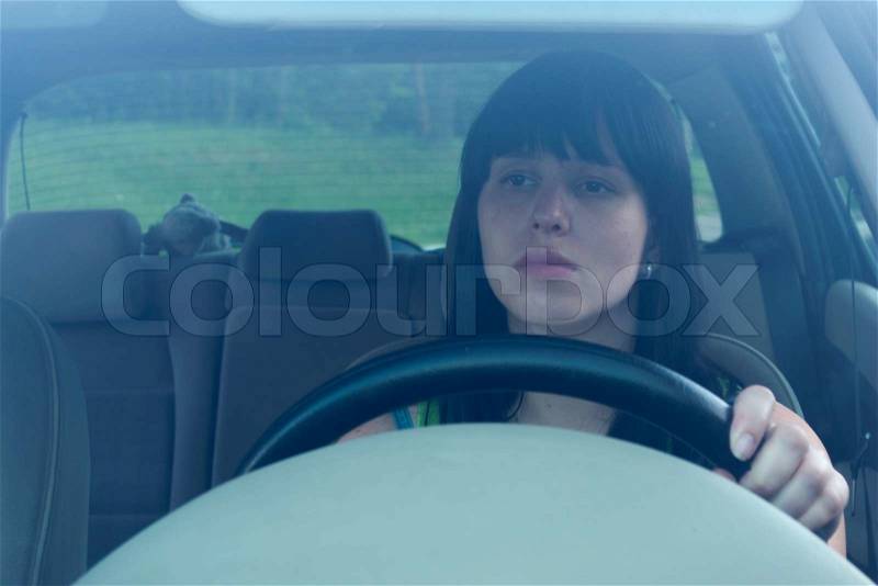 The woman drives the car, stock photo