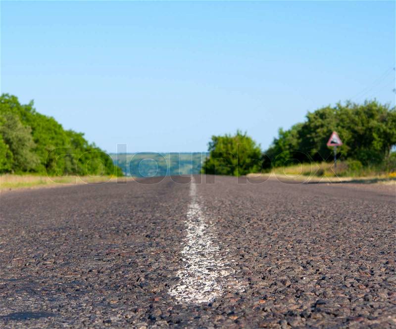 Road into the distance with blue sky, stock photo