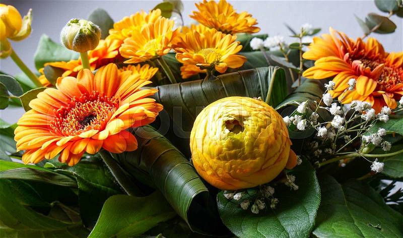 Bouquet of orange flowers, perfect for Mothers day or birthdays. Peonies, Bridal Veils, green leaves and daisies, stock photo