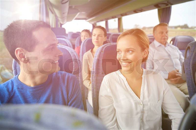 Transport, tourism, road trip and people concept - group of happy passengers or tourists in travel bus, stock photo