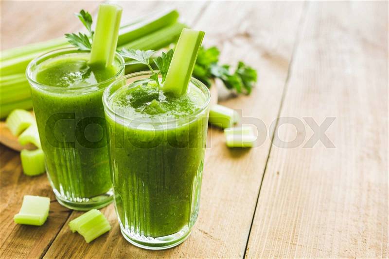 Green smoothie with celery and spinach in two glasses, stock photo