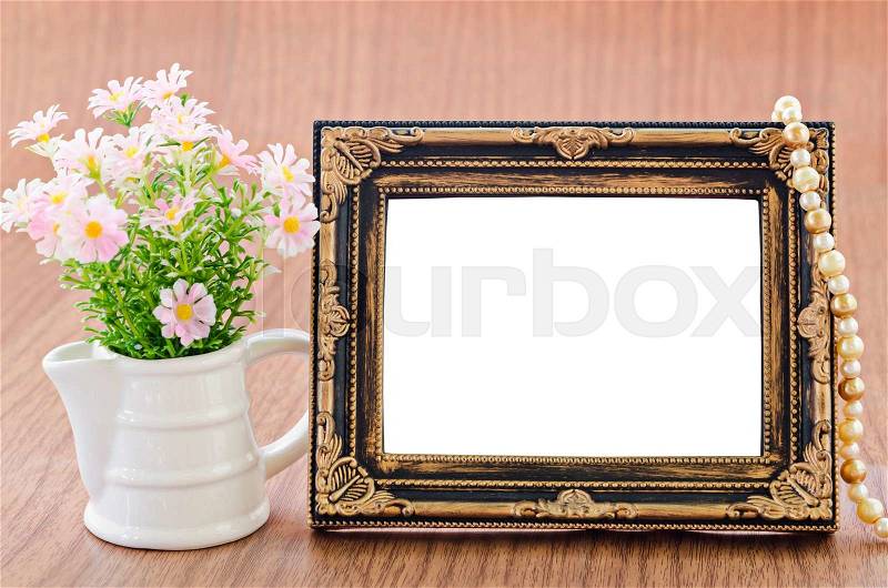 Flowers vase and vintage picture frame on wooden desktop, saved clipping path, stock photo