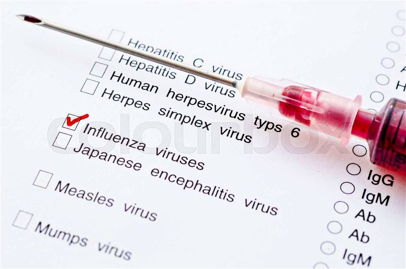 Red mark on Influenza virus screening form test with sample blood in syringe, stock photo