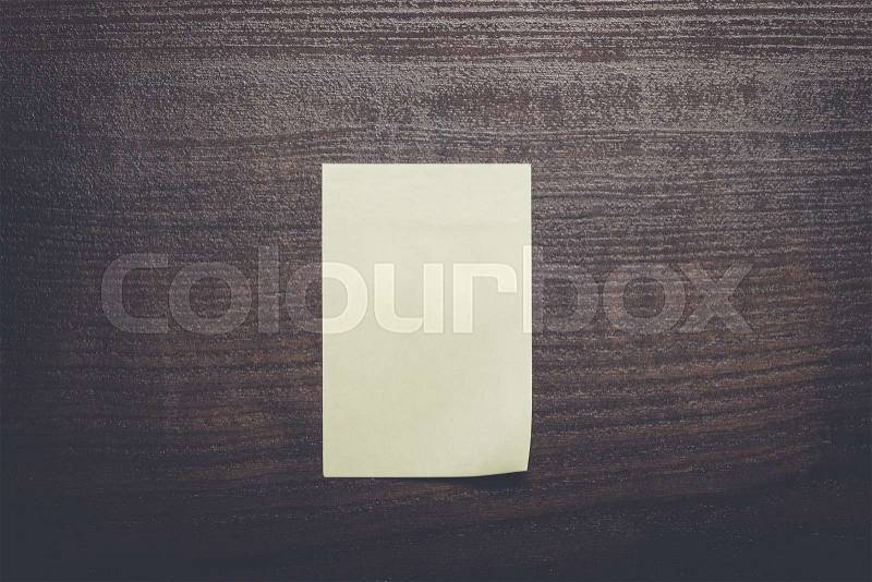 Blank sticker on the brown wooden table, stock photo