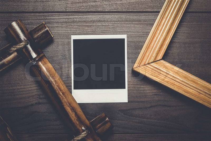 Empty frames and old photo on the wooden table, stock photo
