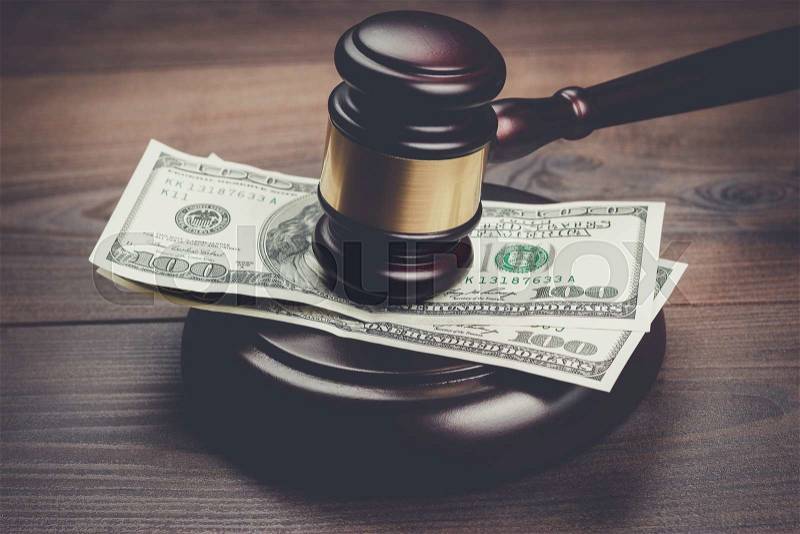 Judge gavel and money on brown wooden table concept, stock photo