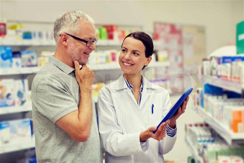 Medicine, pharmaceutics, health care and people concept - happy pharmacist with tablet pc computer and senior man customer at drugstore, stock photo