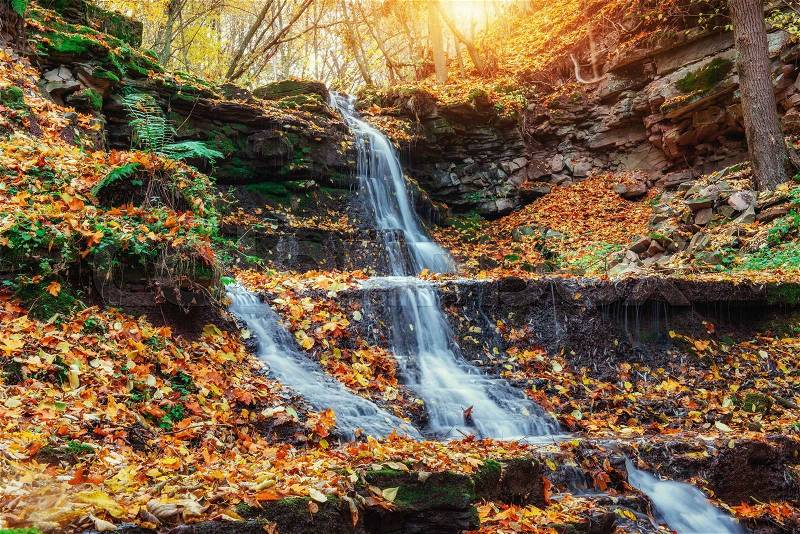 Waterfall in autumn sunlight, stock photo