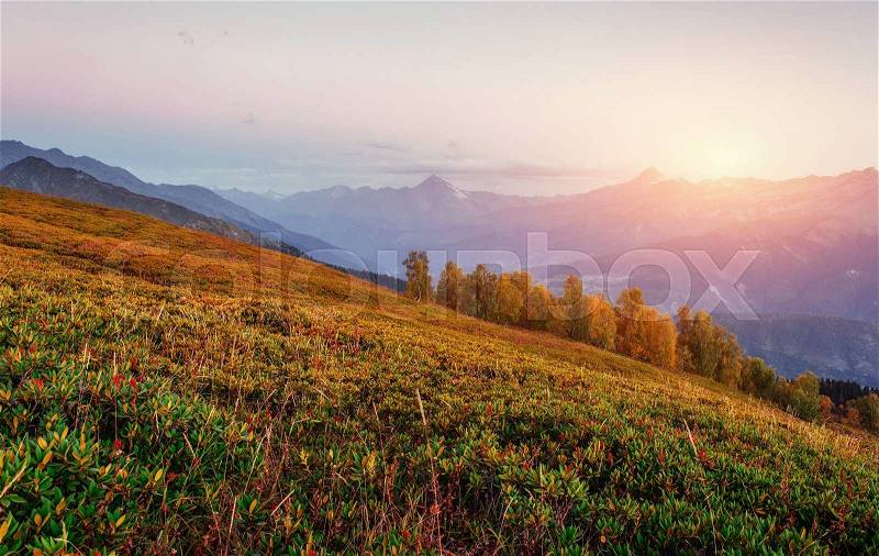 Sunset over snow-capped mountain peaks. View of the mountain with Mount Ushba Mheyer, Georgia. Europe, stock photo