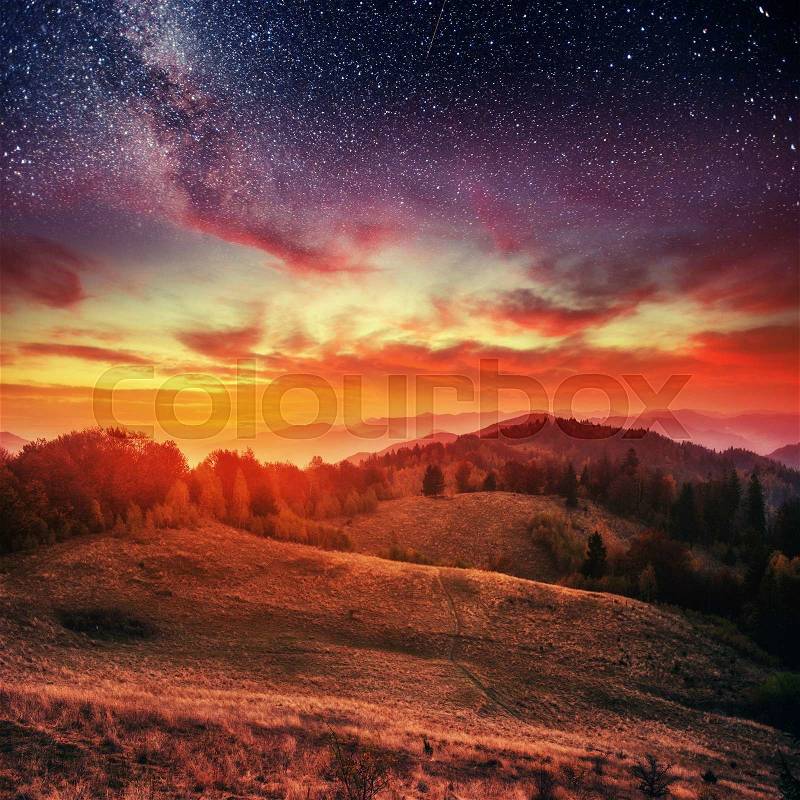 Mountain range in the Carpathian Mountains in autumn night under the stars. Fantastic event. Ukraine, Europe, stock photo
