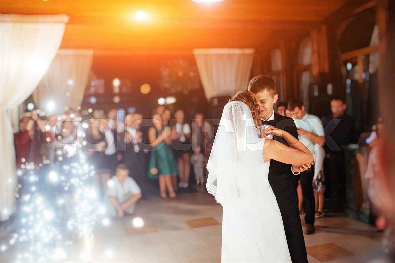 Happy bride and groom and their first dance, wedding in the elegant restaurant with a wonderful light and atmosphere, stock photo