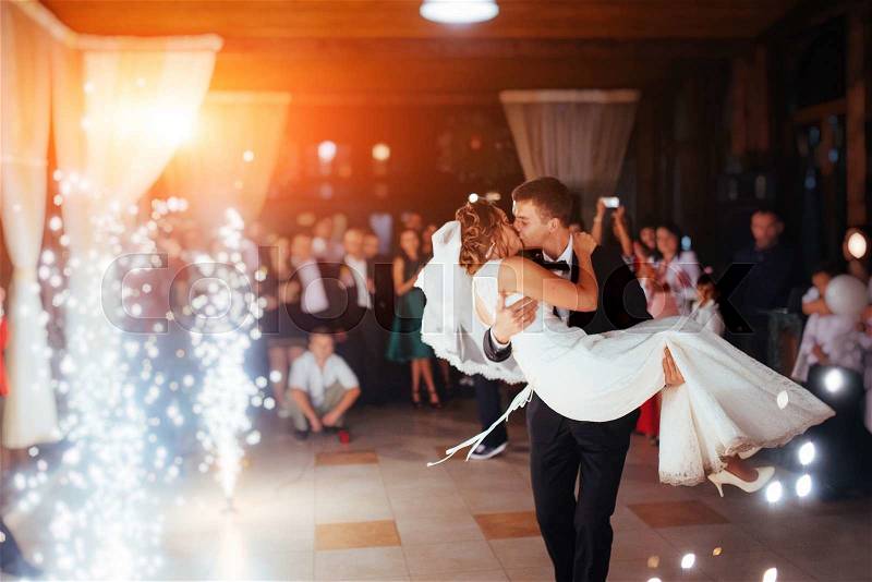 Happy bride and groom and their first dance, wedding in the elegant restaurant with a wonderful light and atmosphere, stock photo