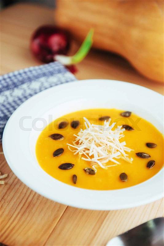 Pumpkin soup in white bowl, dietary vegetable soup, stock photo